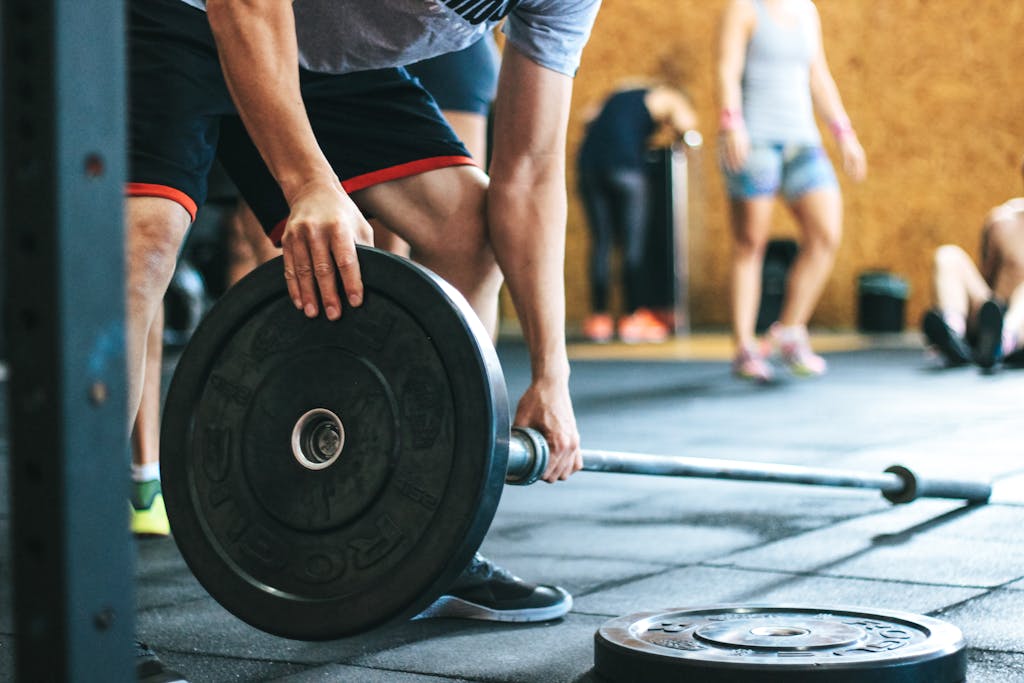 Man Holding Black Barbell